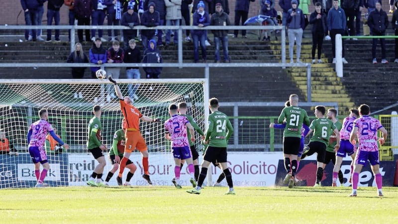 Glentoran&#39;s Aaron McCarey tips Newry&#39;s John McGovern&#39;s header onto the bar during last week&#39;s Irish Cup quarter-final. The Glens were thrown out of the competition last night over a player eligibility issue 
