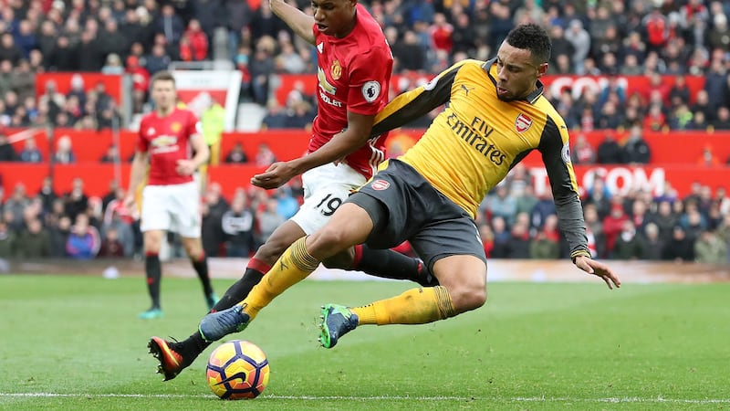 Manchester United's Marcus Rashford (left) and Arsenal's Francis Coquelin battle for the ball during the Premier League match at Old Trafford, Manchester&nbsp;