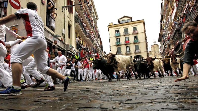 Revellers run in front of Fuente Ymbro&#39;s fighting bulls during the running of the bulls at the San Fermin Festival, in Pamplona, northern Spain Picture: Alvaro Barrientos/AP 