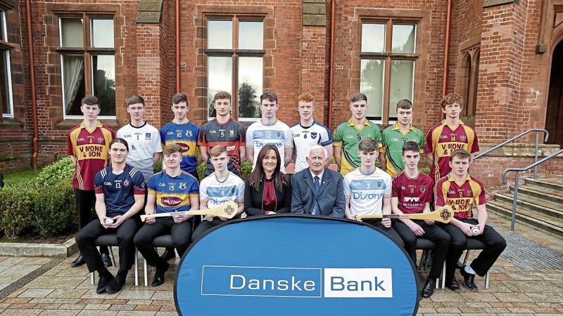 Aisling Press, head of branch banking at Danske Bank and Jimmy Smyth, chairman of Ulster Schools GAA, pictured alongside the 2017-18 Danske Bank Ulster Schools Hurling Allstar awards 