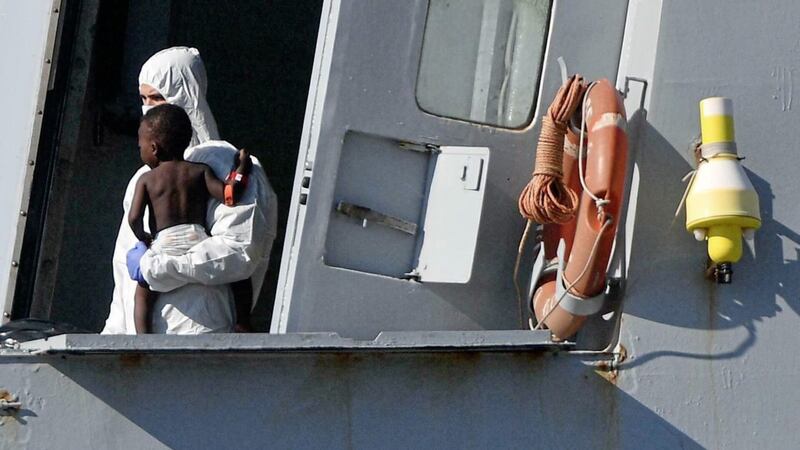 Medical personnel on the Italian navy ship Cigala Fulgosi carry a rescued child as the vessel approaches the harbour in Genoa, Italy earlier this month. The ship rescued 100 migrants from the Mediterranean Sea, where the number of migrants attempting to reach Europe has increased in recent weeks. Picture by Luca Zennaro/ANSA via AP 