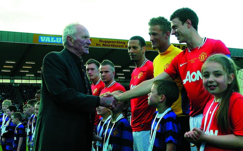 Harry Gregg Testimonial - Irish League XI v Manchester United: Manchester United legend Harry Gregg shakes hands with Jonny Evans before an emotional Testimonial for the former Northern Ireland keeper at Windsor Park, Belfast on Tuesday May 15 2012