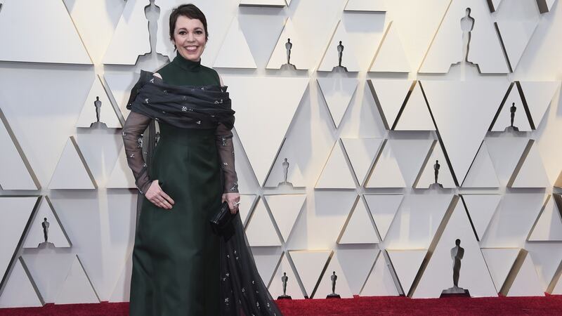 Olivia Colman’s outfit included a nod to her upcoming role in The Crown.
