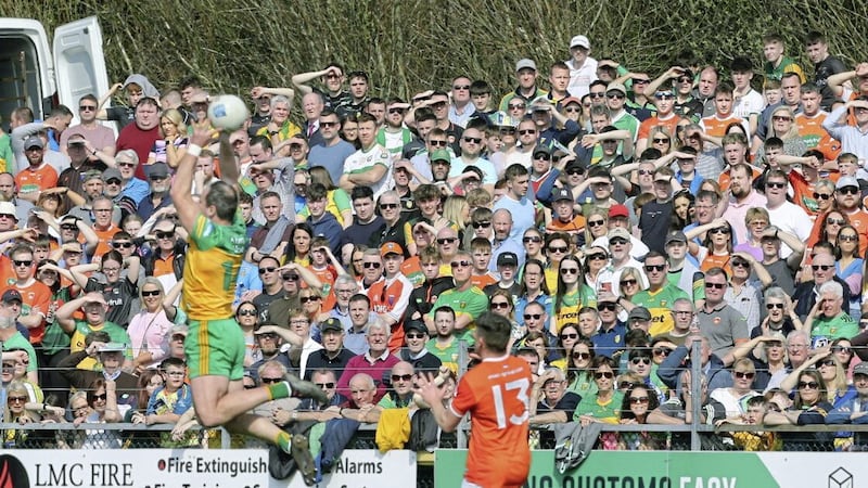 Supporters watch on as Donegal Michael Murphy soars into the air to collect the ball ahead of Aidan Nugent of Armagh during the National Football League Division 1 match played at O&#39;Donnell Park, Letterkenny on Sunday 27th March 2022. Picture by Margaret McLaughlin. 