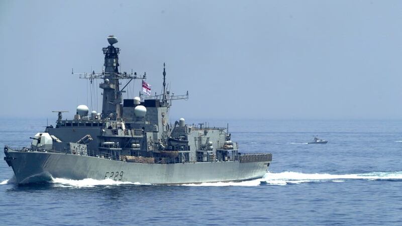 HMS Lancaster sails as Iranian Revolutionary Guard vessels follow behind it in the Strait of Hormuz (Jon Gambrell/AP)