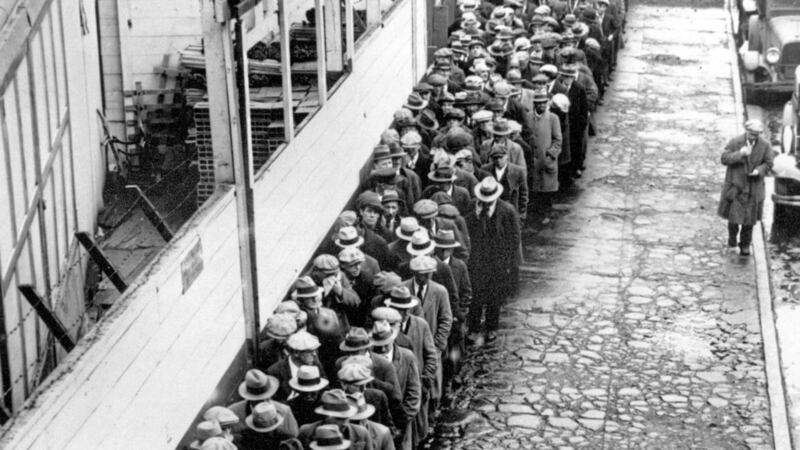 A long line of jobless and homeless men wait outside to get free dinner during the Great Depression 