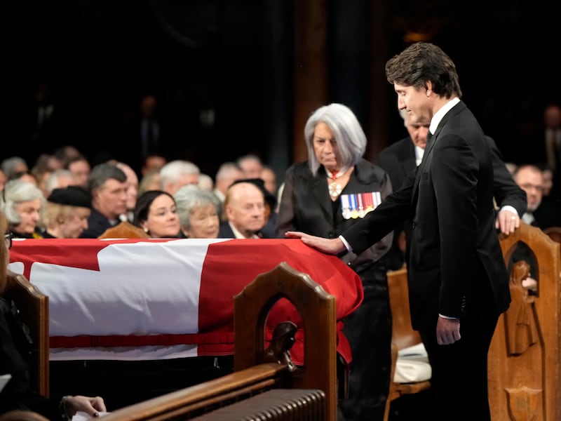 Prime Minister Justin Trudeau places his hand on the coffin (Ryan Remiorz /The Canadian Press/AP)