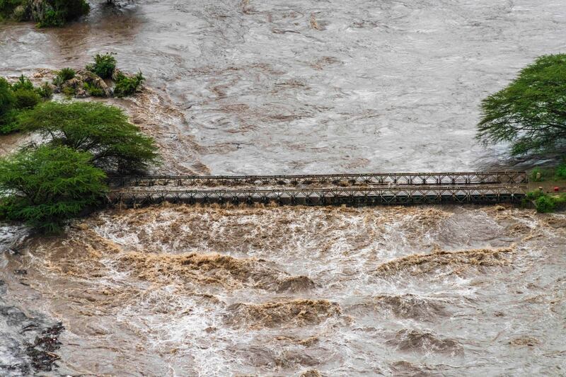 Floodwater covers a bridge in the flooded Maasai Mara National Reserve (Bobby Neptune/AP)