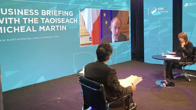Taoiseach Micheal Martin addresses the virtual event watched by NI Chamber chief executive Ann McGregor and host Mark Davenport 