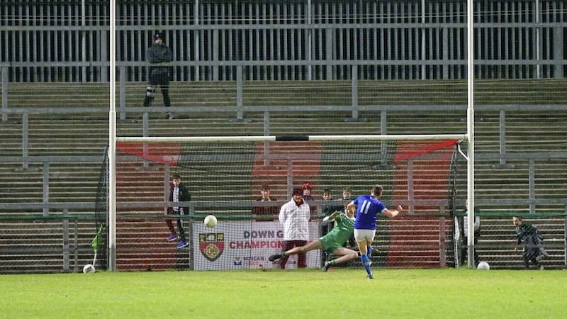 Warrenpoint&#39;s Alan Davidson scores a penalty past Callum Grant of Burren during their Down SFC quarter-final match at P&aacute;irc Esler on Monday. If nothing can separate them after normal time and extra-time, then surely they both deserve another crack at it in a replay 				Picture: Louis McNally 