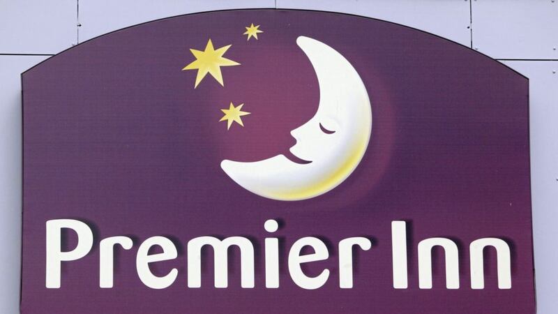 Premier Inn owner Whitbread has swung to a half-year loss 