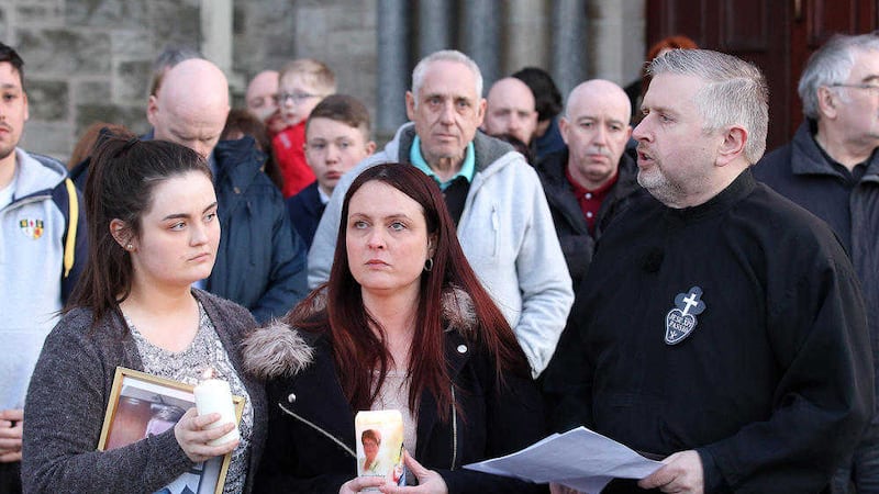 Seana McGibbon with mother Joanne McGibbon and rector of Holy Cross Church Fr Gary Donegan at a candle light vigil in April. Picture by Philip Walsh 
