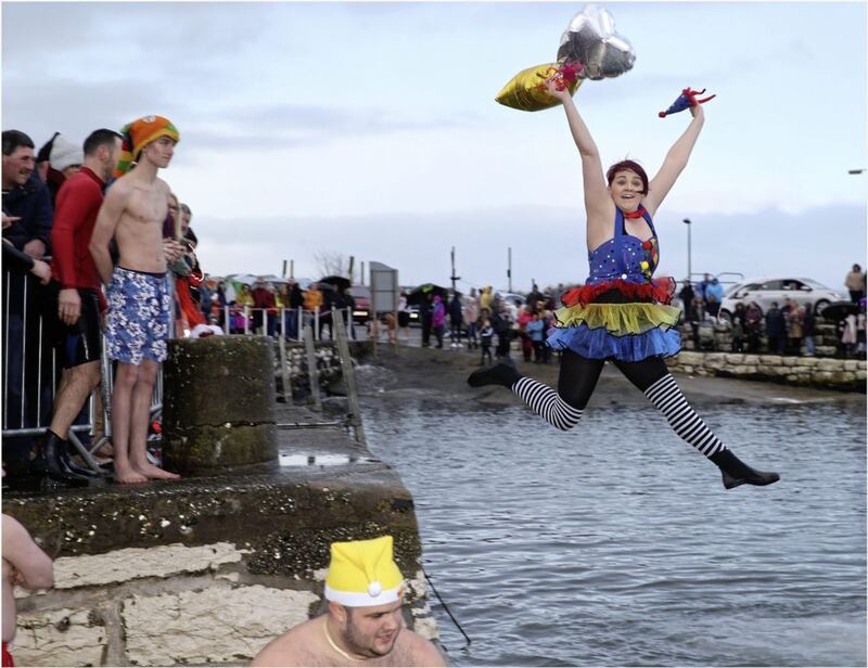 Megan McClements shows her superwoman powers as she jumps off the harbour wall. Picture by Hugh Russell