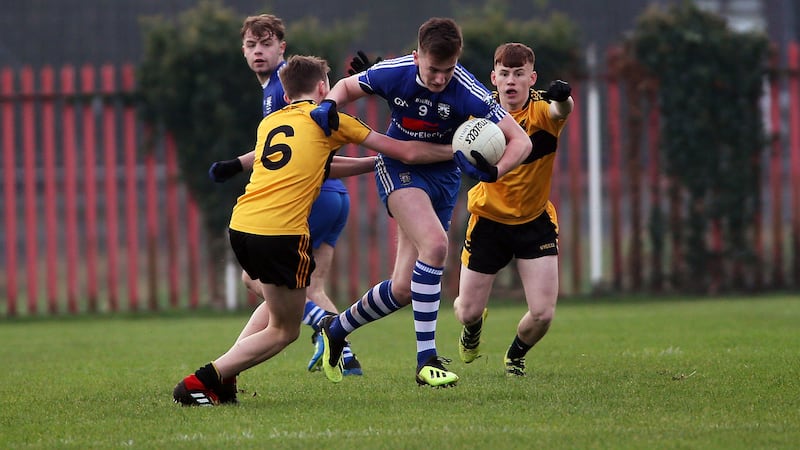 Bellaghy's Kealan Friel bursts past St Eunan's Sean Ryan and Conor O'Donnell during the FonaCab Ulster Minor Football semi-final on Wednesday December 26 2018 at St Paul's GAC, Belfast. Picture by Seamus Loughran&nbsp;