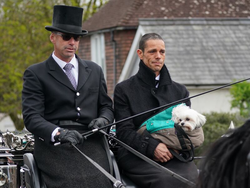 Husband of Paul O’Grady Andre Portasio rides with the funeral cortege