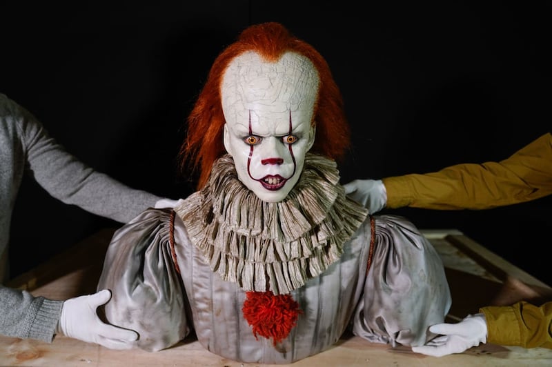 Propstore employees move a Pennywise (Bill Skarsgard) make up display from the 2019 film IT: Chapter Two