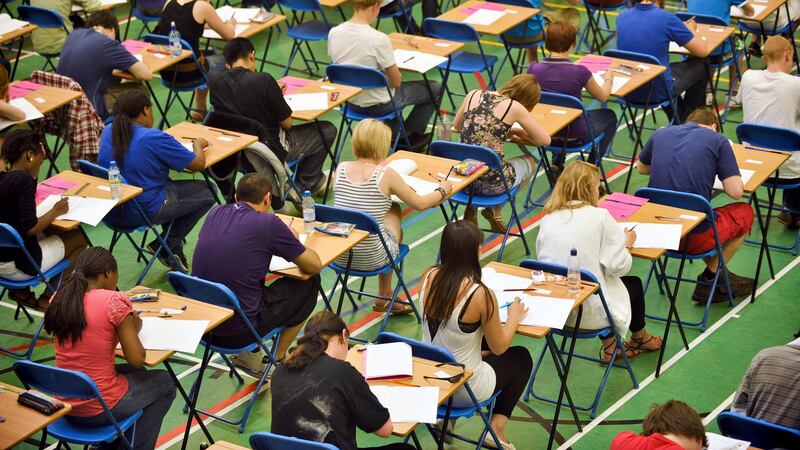 A-level students sit an A-level maths exam inside a sports hall