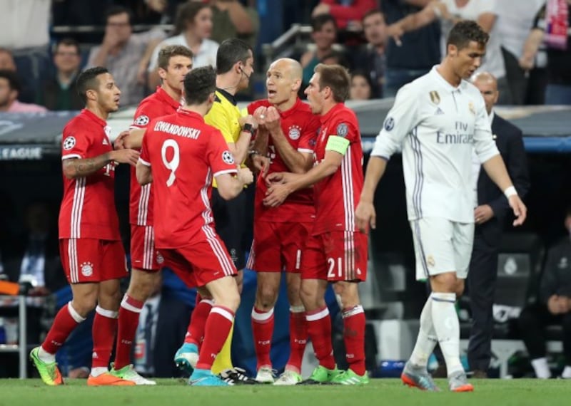 Bayern Munich players speak to the referee in the Champions League