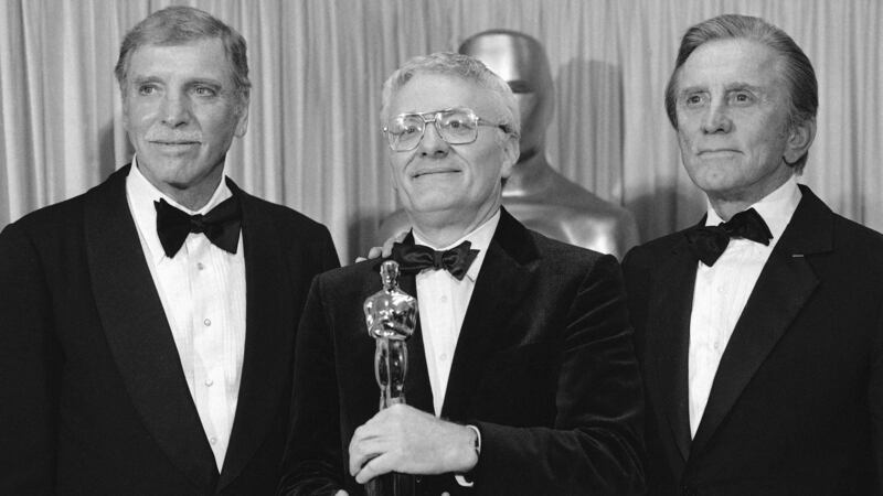 Actors Burt Lancaster, left, and Kirk Douglas, right, stand with Peter Shaffer, winner of the best adapted screenplay Oscar for Amadeus, during the Academy Awards in Los Angeles in 1985. Picture by Associated Press&nbsp;
