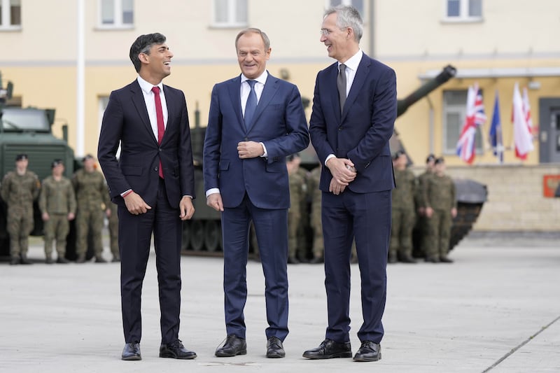 Prime Minister Rishi Sunak, left, with Poland’s Prime Minister Donald Tusk, centre, and Nato Secretary-General Jens Stoltenberg at a barracks in Warsaw