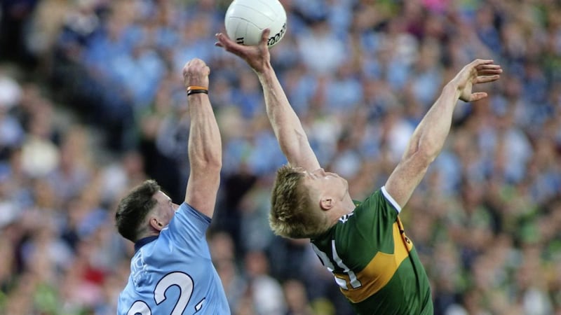 Philly McMahon jumps to get a fist to the ball in an aerial duel with Kerry&#39;s Tommy Walsh in this year&#39;s All-Ireland replay. Picture by Hugh Russell. 