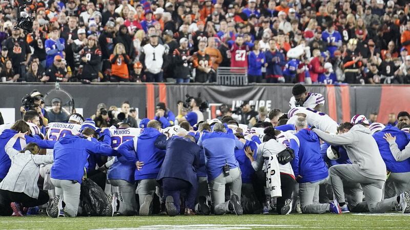 Buffalo Bills players and staff pray for Damar Hamlin during the first half of the NFL game against the Cincinnati Bengals on January 2. The game was postponed after Bills player Hamlin collapsed.