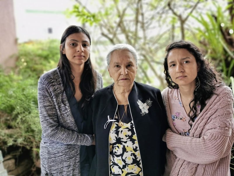 Laura Z&uacute;niga C&aacute;ceres and sister Bertita Z&uacute;niga C&aacute;ceres flank their grandmother, Austra Berta Flores at her home in La Esperanza. Picture from Tr&oacute;caire