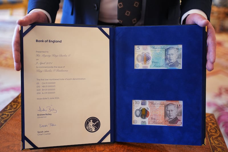 The £5 and £10 bank notes bearing the King’s portrait in a special presentation book