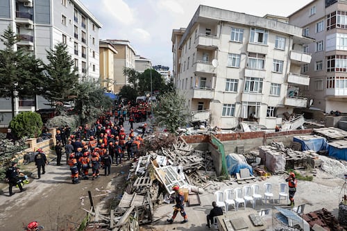 Partial building collapse in Istanbul kills two and traps at least three people