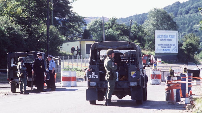 Irish army personnel guard a border customs post in the 1980s 