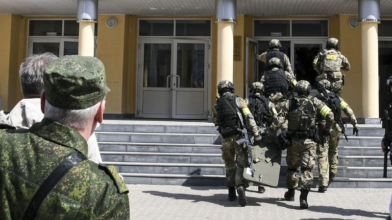A Russian police special unit near the scene at a school after a shooting in Kazan, Russia, Tuesday, May 11, 2021 (Tatarstan Presidential Press Service via AP)&nbsp;