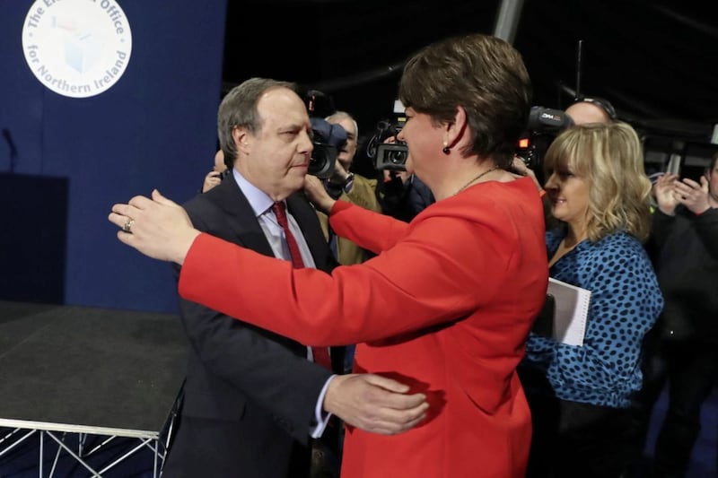 DUP deputy leader Nigel Dodds is embraced by party leader Arlene Foster after losing the Belfast North seat at the Titanic Exhibition Centre, Belfast. Picture by Liam McBurney/PA 