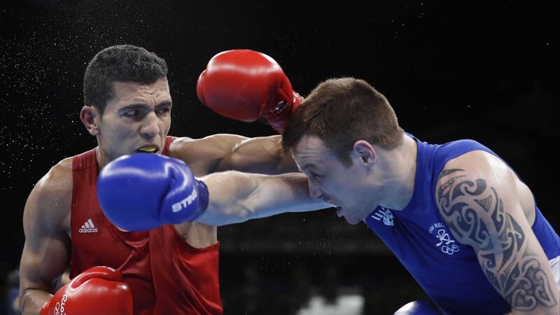 Ireland's Steven Donnelly, right, and Morocco's Mohammed Rabii exchange punches during the welterweight 69-kg quarterfinals boxing match at the 2016 Summer Olympics in Rio de Janeiro