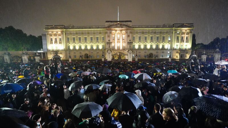 Members of the public gather outside Buckingham Palace following the death of Queen Elizabeth II (Victoria Jones/PA)