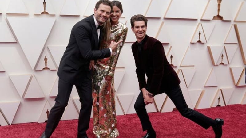 &nbsp;Jamie Dornan, from left, Amelia Warner and Andrew Garfield arrive at the Oscars on Sunday, March 27, 2022, at the Dolby Theatre in Los Angeles (Jae C. Hong/AP)