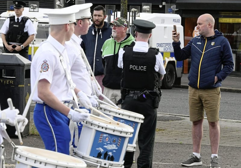 Alan Lewis- PhotopressBelfast.co.uk 12-7-2019.Prominent republican Dee Fennell videos the Orange Order Parade as it passes the Ardoyne shopfronts this morning on its way to one of the annual &#39;Twelfth&#39; demonstrations being held across Northern Ireland on the biggest marching day of the Orange Order&#39;s calendar..A large police presence was on hand at the once controversial &#39;flashpoint&#39; but only around half a dozen people in total answered a call by nationalist community group GARC to gather at 8.00am to observe the parade that passed off peacefully.. 