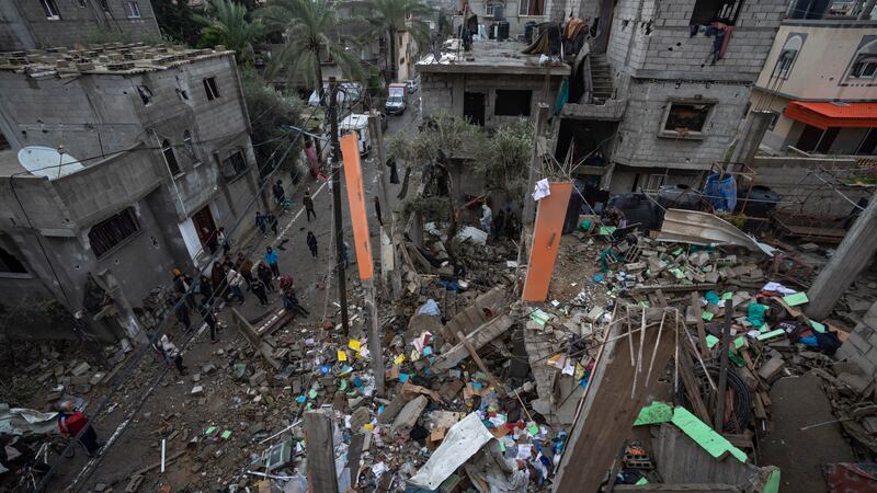 Palestinians look at the destruction after an Israeli air strike in Rafah (AP Photo/Fatima Shbair)