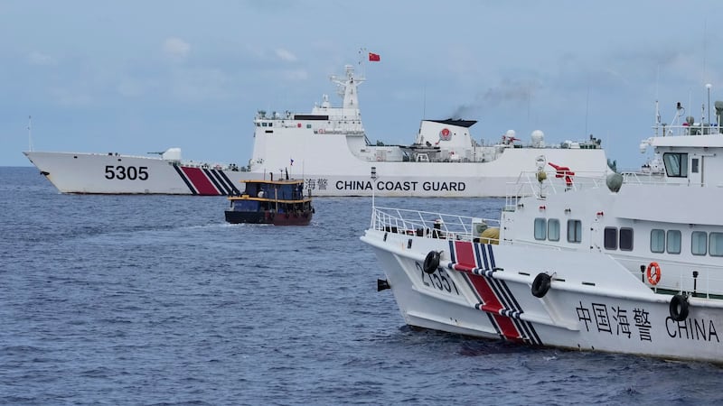 Two Philippine navy-manned boats manage to breach a Chinese coast guard blockade in a dangerous confrontation in the disputed South China Sea and deliver food and other supplies to Filipino forces guarding the contested Second Thomas Shoal (Aaron Favila/AP)