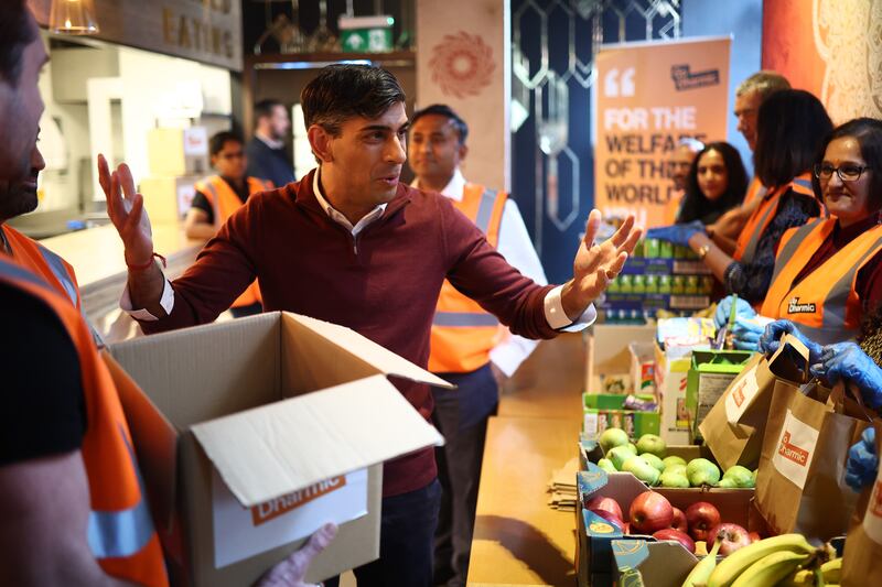 Rishi Sunak meets volunteers preparing food packages during a visit to a north London community centre