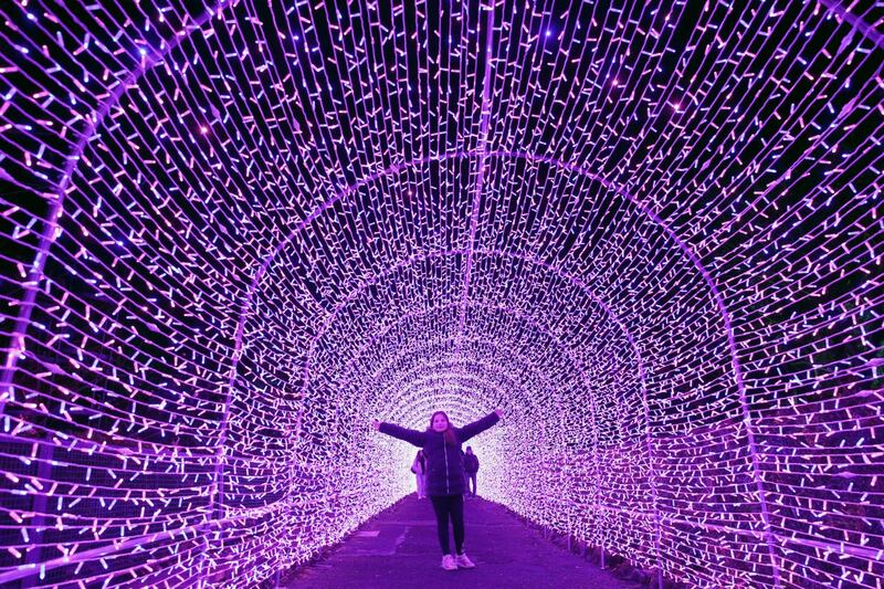Girl stands in light tunnel