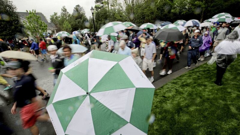 Patrons head for the exits at Augusta after the first official practice day for the 2017 Masters was interrupted by weather warnings. Picture: AP