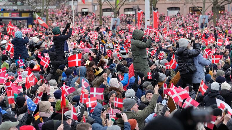 People try to get a view as Denmark’s Crown Prince Frederik arrives at Christiansborg Palace in Copenhagen (AP Photo/Martin Meissner)