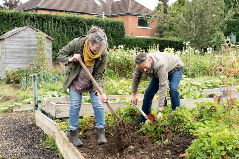 Jill Hines and David Hines (right) digging over one of the raised beds at Knockbreda Community Wildlife Garden