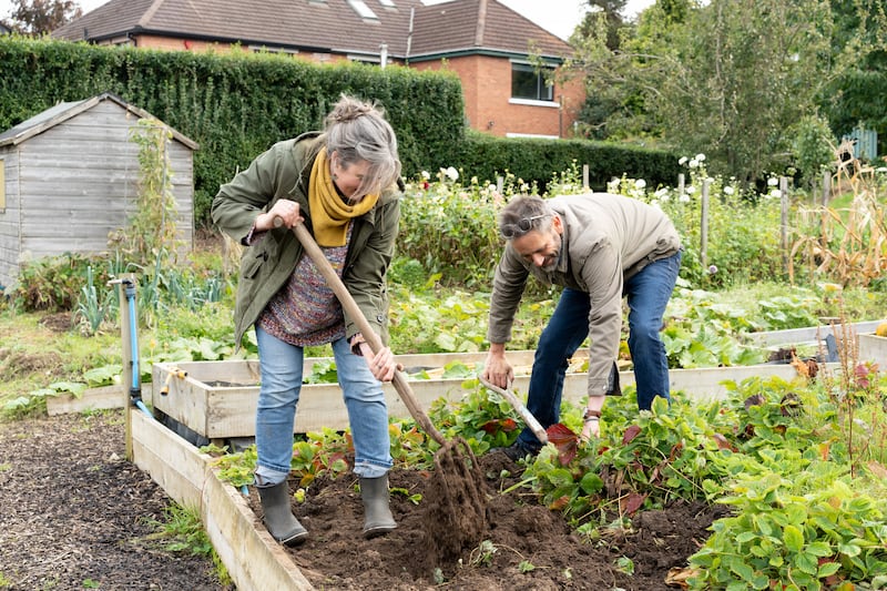 Jill Hines and David Hines (right) digging over one of the raised beds at Knockbreda Community Wildlife Garden