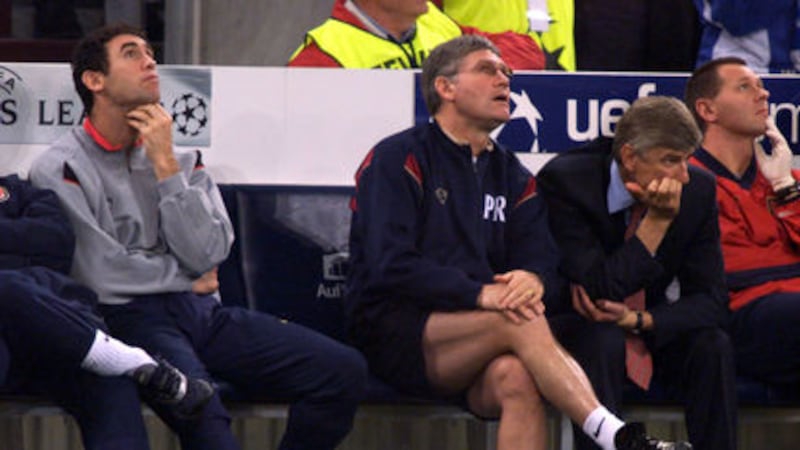Arsenal's Martin Keown (left) and Pat Rice (centre) look up to watch a replay of the 2nd Schalke goal as Arsene Wenger (second right) looks to the pitch during the Champions League group C match at Arena Auf Schalke Gelsenkirchen Germany on Tuesday October 30 2001.&nbsp;