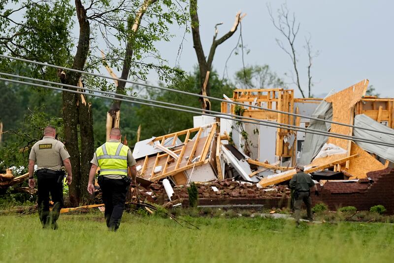 Maury County Sheriffs Deputies search through a storm damaged home in Columbia, Tennessee (George Walker/AP)