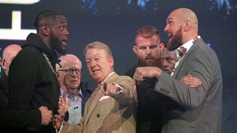 Deontay Wilder and Tyson Fury react as promoter Frank Warren (centre) keeps them apart during a press conference at BT Sport Studio, London&nbsp;