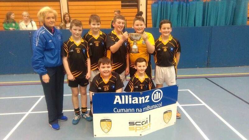 Holy Child overcame stiff competition from Bunscoil Phobal Feirste, Holy Trinity and Gaelscoil na bhF&aacute;l to retain the Belfast Antrim Allianz Cumann na mBunscol Indoor Hurling title. Mrs Moran is pictured with Cahir Carberry, Conor Boyle, Diarmuid O'Sullivan, Adam Murray, Shea Fagan, Patrick Lynch and Conor Connolly