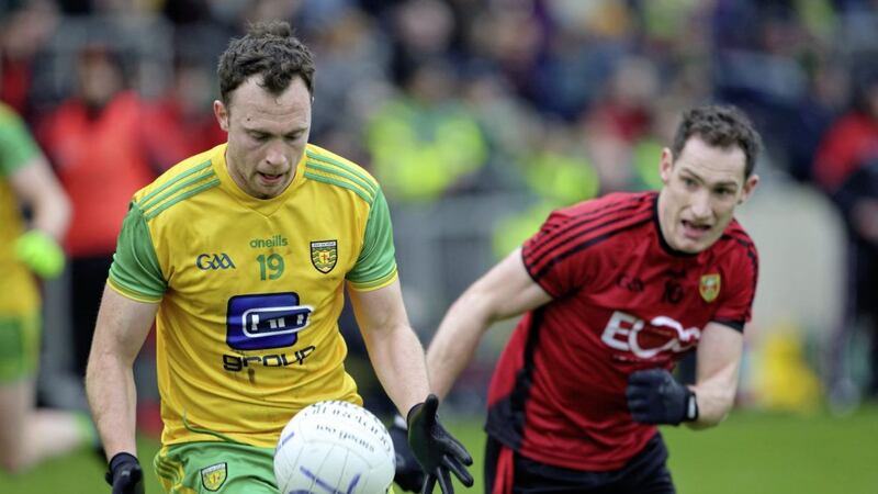 Donegal's Martin McElhinney gets away from Down's Rory Mason. McElhinney bagged four points in Donegal's 10-point McKenna Cup victory Picture by Cliff Donaldson