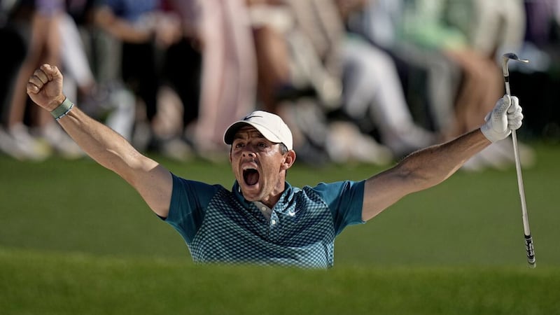Rory McIlroy reacts after holing out from the bunker for a birdie during the final round at the 2022 Masters golf tournament. 